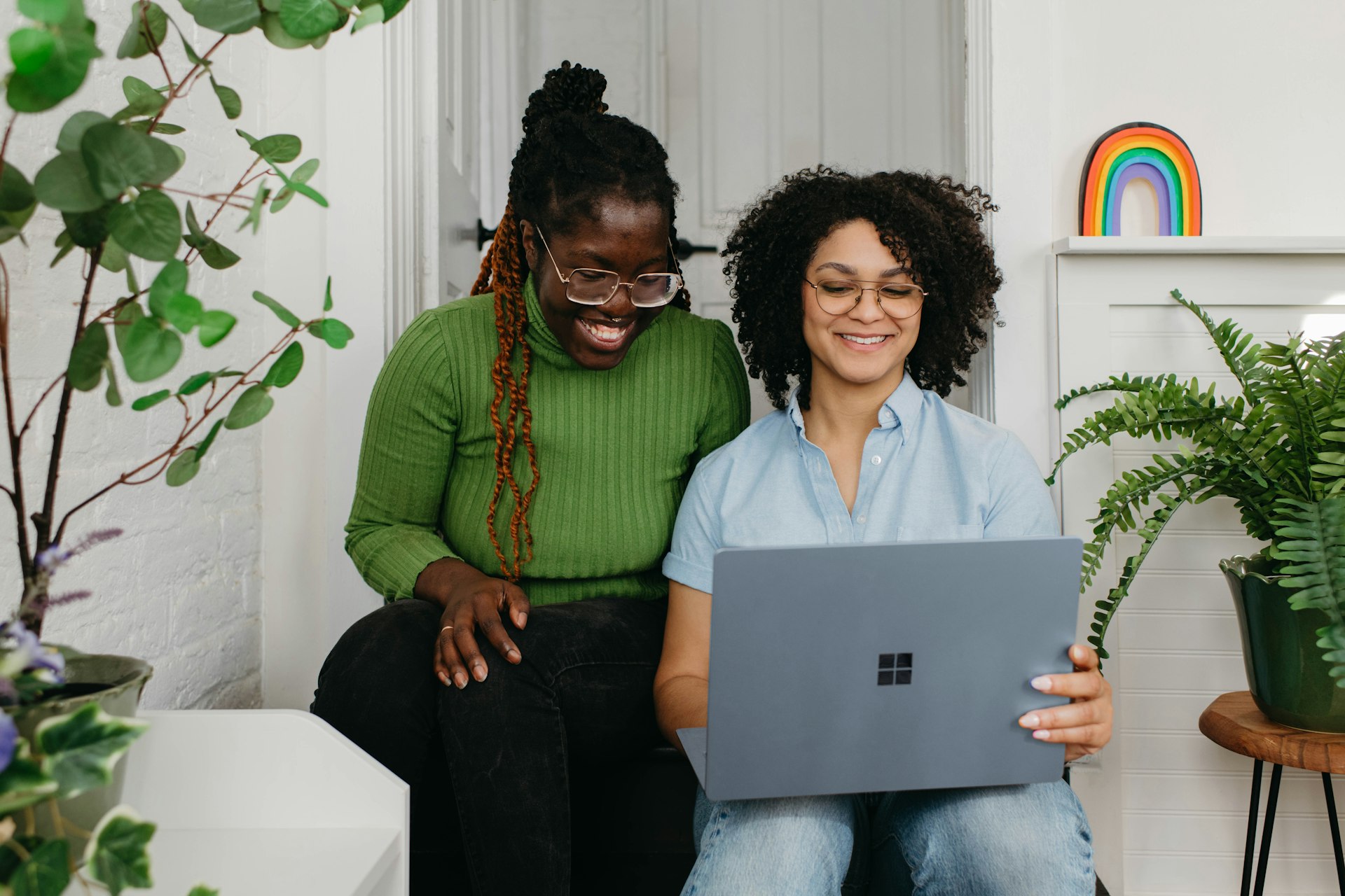 a couple of women sitting next to each other on a couch